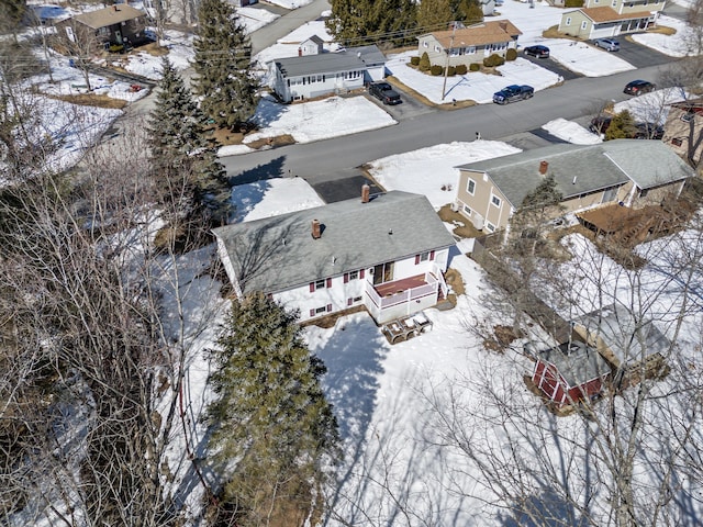 snowy aerial view featuring a residential view