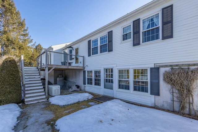 rear view of property featuring stairway and a wooden deck