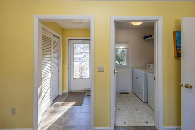 clothes washing area featuring visible vents, baseboards, light tile patterned floors, laundry area, and washer and dryer