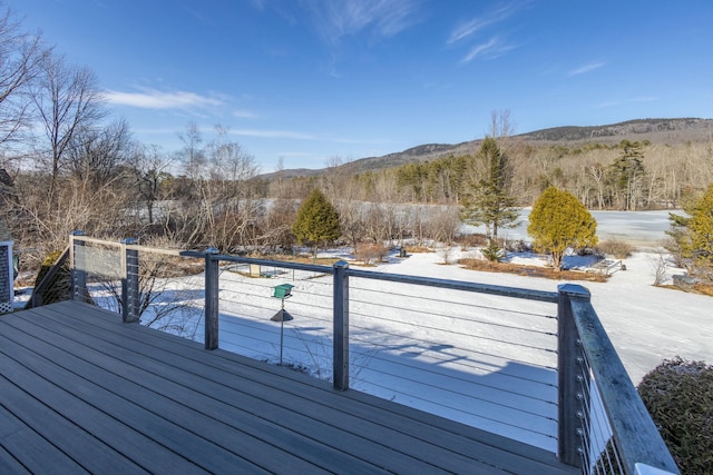 snow covered deck featuring a mountain view