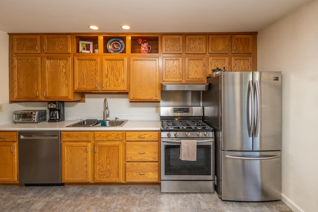 kitchen featuring a sink, light countertops, under cabinet range hood, and stainless steel appliances