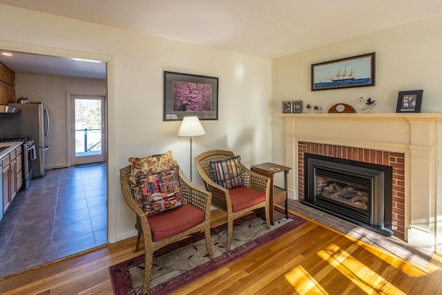 sitting room with wood finished floors and a fireplace