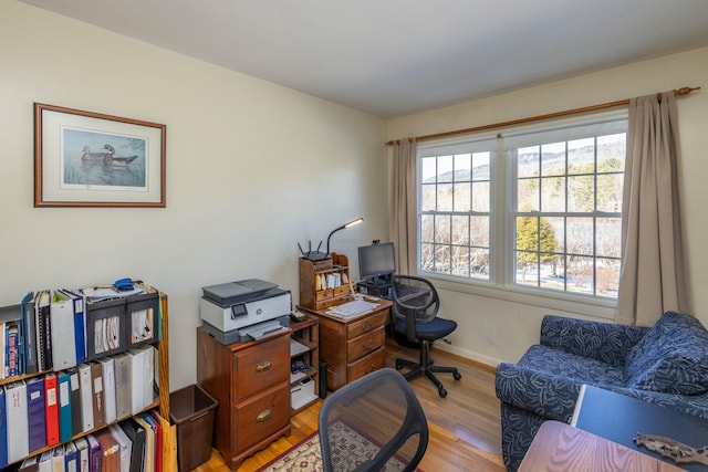 office area with baseboards and light wood-type flooring