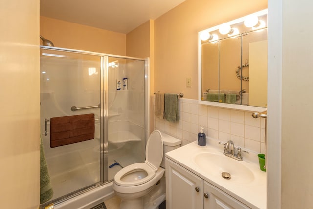 full bathroom featuring a shower stall, tile walls, vanity, and toilet