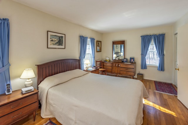 bedroom featuring baseboards and hardwood / wood-style floors