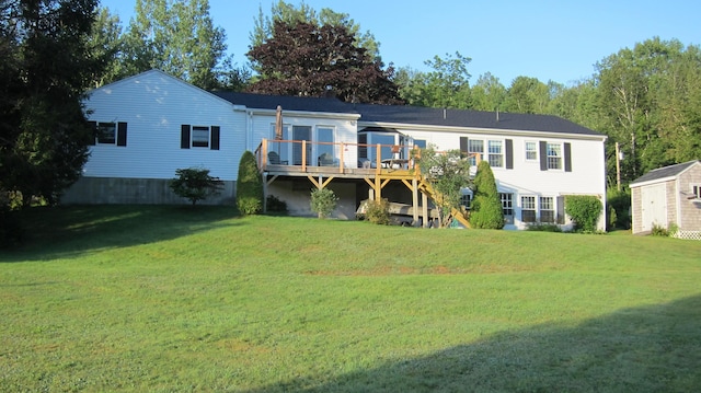 rear view of house with a shed, stairway, a wooden deck, a yard, and an outdoor structure