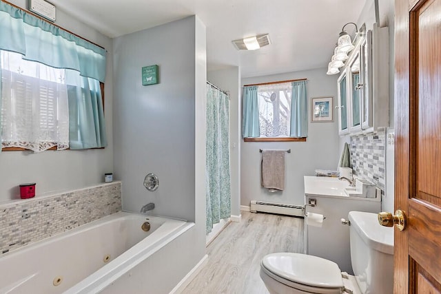 bathroom featuring vanity, toilet, a whirlpool tub, visible vents, and baseboard heating