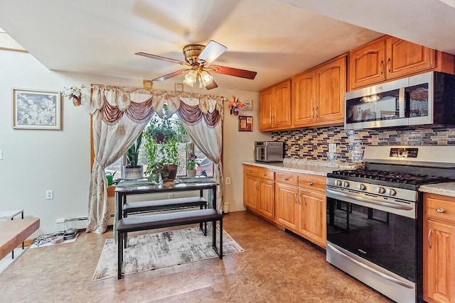 kitchen with light countertops, tasteful backsplash, appliances with stainless steel finishes, brown cabinetry, and ceiling fan