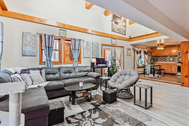 living room with ceiling fan and light wood-style flooring