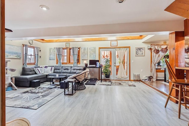 living area with baseboards and wood finished floors