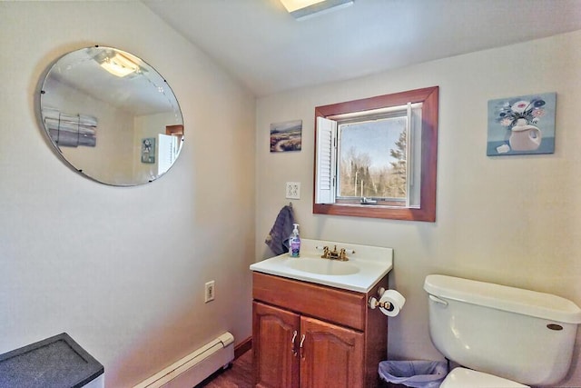 half bathroom with toilet, vanity, and a baseboard heating unit