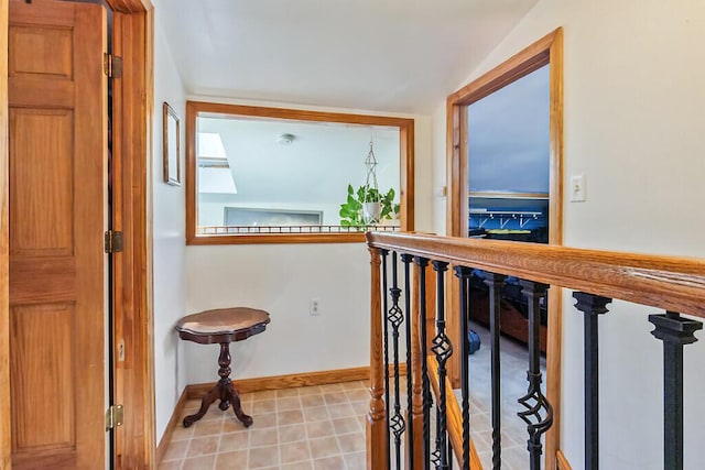 hall with light tile patterned floors and baseboards
