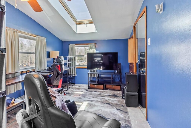office space with ceiling fan and lofted ceiling with skylight