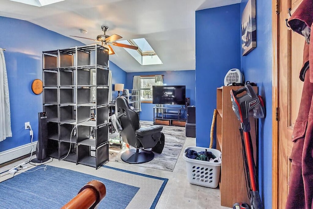 recreation room with ceiling fan, lofted ceiling with skylight, and baseboard heating