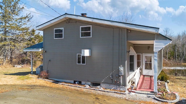 rear view of property with central AC