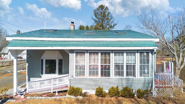 rear view of property with a chimney