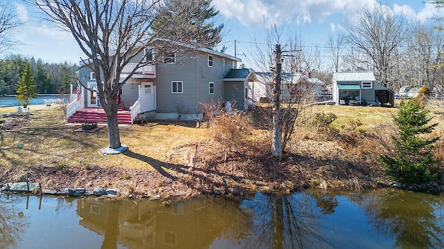 back of property featuring a water view