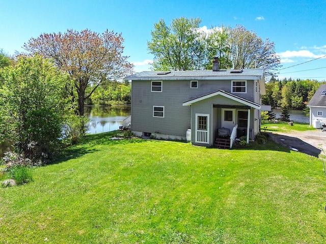 12 Town Line Rd, Belgrade, ME 04917 - rear view of property featuring a lawn, a chimney, and a water view