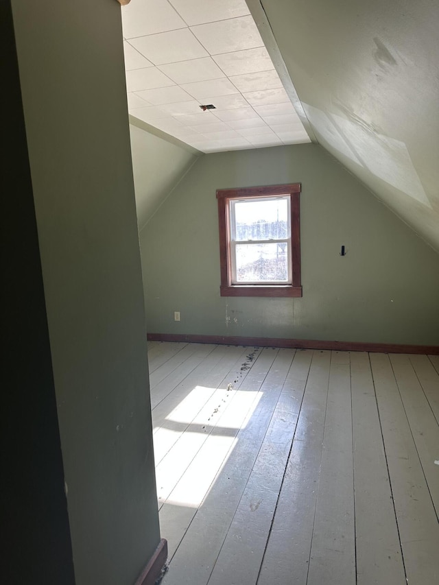 bonus room with vaulted ceiling, baseboards, and hardwood / wood-style floors