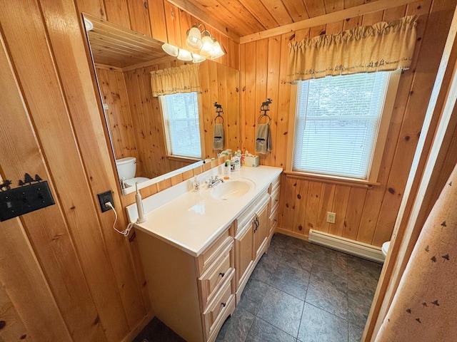 bathroom featuring wooden walls, toilet, baseboard heating, wooden ceiling, and vanity