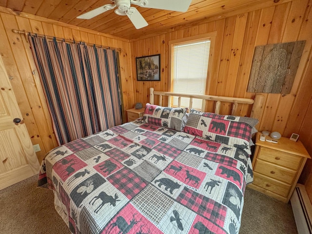 bedroom featuring carpet flooring, wood walls, wooden ceiling, and a baseboard radiator