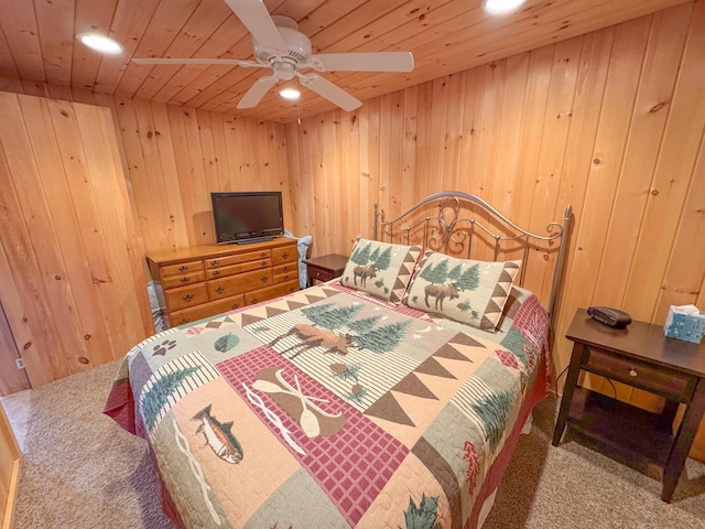 carpeted bedroom with a ceiling fan, wooden walls, recessed lighting, and wood ceiling