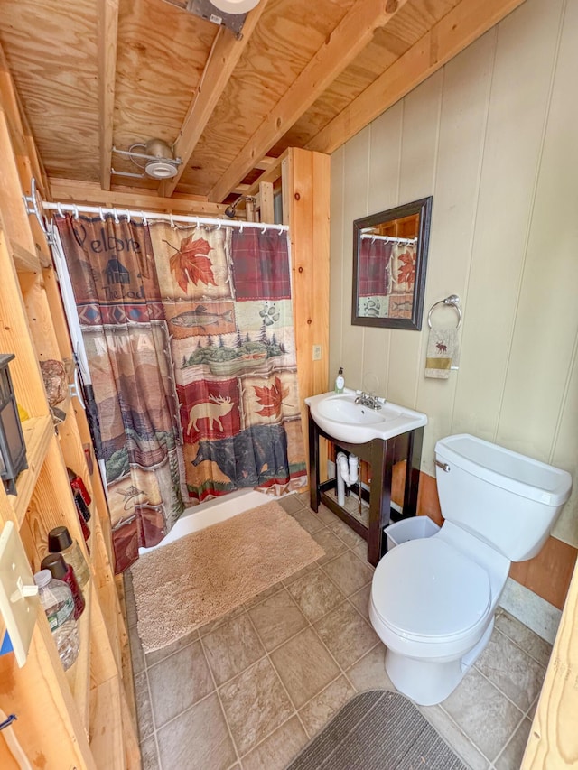 bathroom featuring curtained shower and toilet