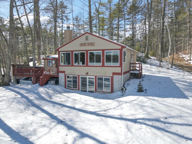 view of front of house with a wooden deck and a chimney