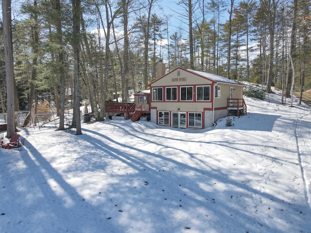 exterior space with a wooden deck and a chimney