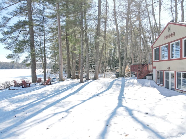 yard covered in snow with stairway