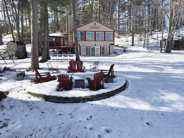 snow covered house with an outdoor structure