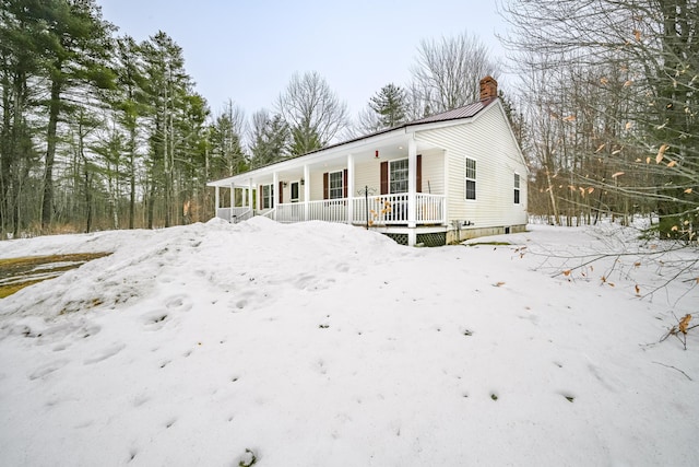 view of front of property with a porch and a chimney