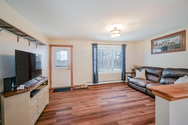 living room featuring light wood finished floors and baseboard heating