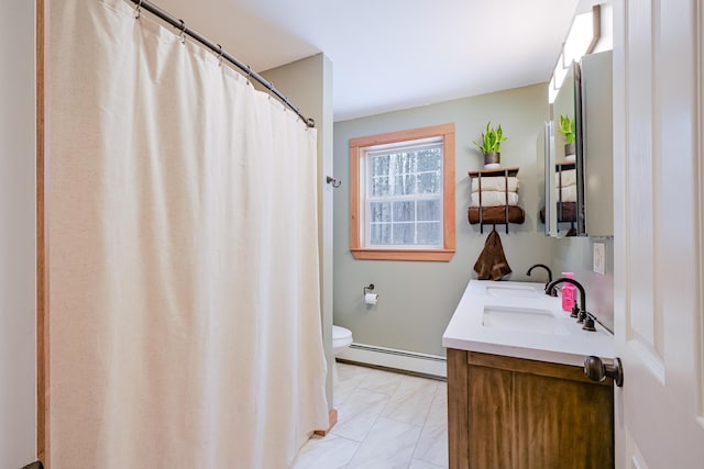 bathroom with toilet, a shower with shower curtain, double vanity, baseboard heating, and a sink