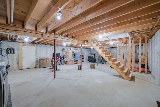 unfinished basement featuring stairs