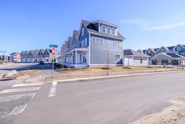 exterior space featuring a residential view, curbs, traffic signs, and sidewalks