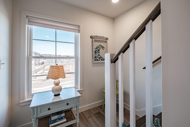 interior space with baseboards and wood finished floors