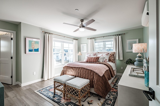 bedroom featuring a ceiling fan, baseboards, and light wood finished floors