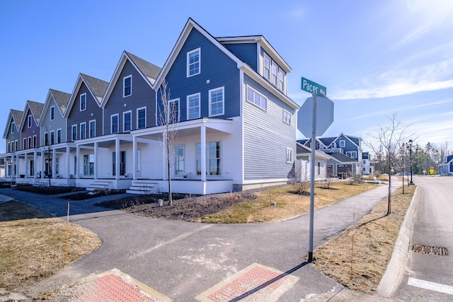 view of home's exterior featuring a porch and a residential view