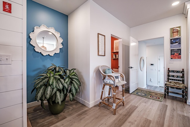 corridor featuring recessed lighting, baseboards, and wood finished floors