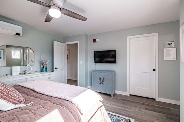 bedroom with baseboards, light wood-style floors, ceiling fan, and a wall mounted AC