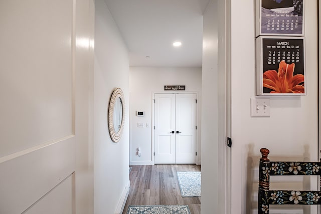 hall with recessed lighting, baseboards, and wood finished floors