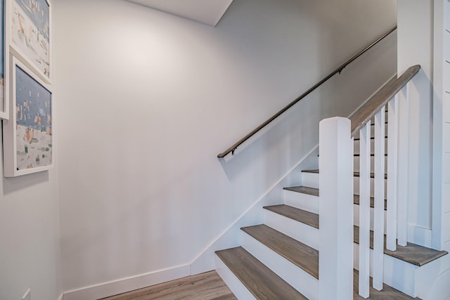 stairs with baseboards and wood finished floors