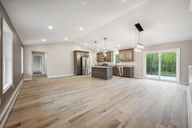 67 Stacey Ln, Kenduskeag, ME 04450 - kitchen featuring appliances with stainless steel finishes, open floor plan, a baseboard heating unit, light wood finished floors, and vaulted ceiling