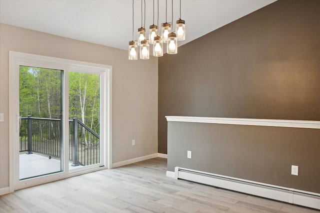 67 Stacey Ln, Kenduskeag, ME 04450 - empty room featuring a baseboard heating unit, wood finished floors, baseboards, and a chandelier