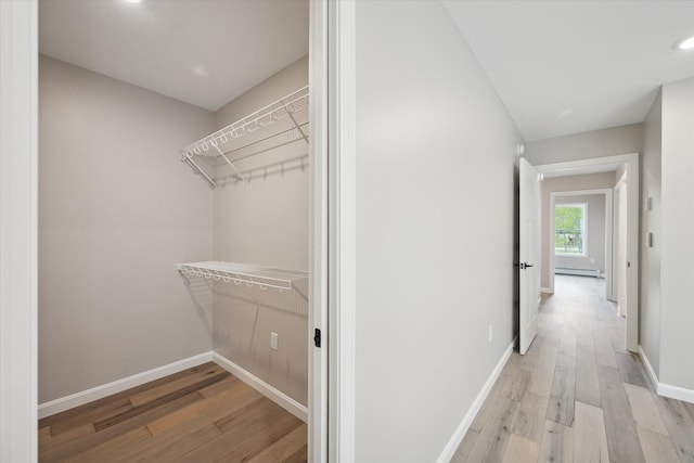 67 Stacey Ln, Kenduskeag, ME 04450 - spacious closet with light wood-style floors and a baseboard radiator