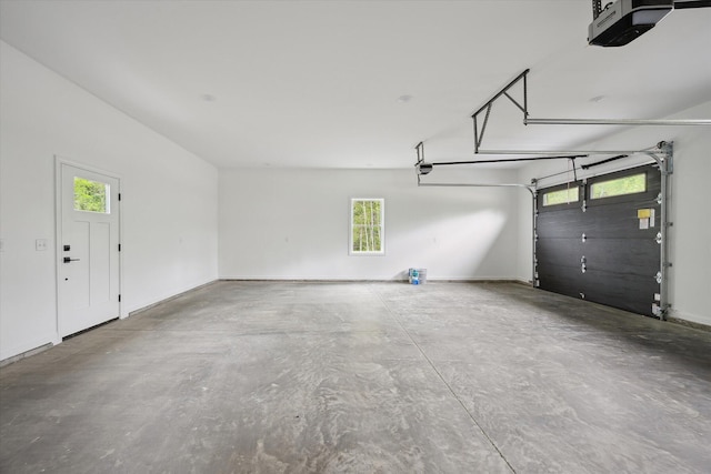 67 Stacey Ln, Kenduskeag, ME 04450 - garage featuring a garage door opener and baseboards