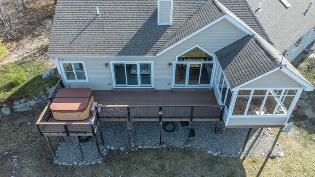 back of house with a shingled roof and a deck