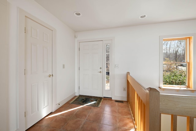 tiled foyer entrance featuring recessed lighting, baseboards, and visible vents