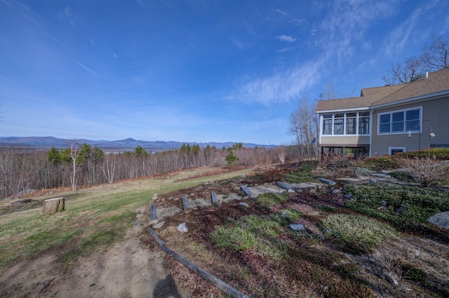 view of yard featuring a mountain view and a sunroom
